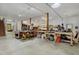Spacious workshop featuring multiple workbenches, exposed wooden beams, and ample lighting throughout the space at 123 Beech Forest Way, Pittsboro, NC 27312
