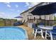 Inviting backyard with a pool, deck, seating area, and a dining table for outdoor entertaining at 123 Hawick Ct, Zebulon, NC 27597