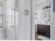 Hallway view of half bathroom with modern vanity, shiplap accent wall, and stylish mirror at 123 Hawick Ct, Zebulon, NC 27597