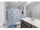 Bathroom with blue accents featuring a patterned shower curtain and decorative fish-themed wall decor at 123 Hawick Ct, Zebulon, NC 27597