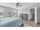 Comfortable bedroom with light grey walls, a modern ceiling fan, wood floors, and a view to the hallway at 123 Hawick Ct, Zebulon, NC 27597