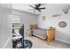 Cozy room designed for teenagers, with an arcade-style dart board, a desk with PC and a wooden bed at 123 Hawick Ct, Zebulon, NC 27597