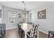 Bright and airy dining room featuring a rustic dining table, chandelier, and views of the outdoors at 123 Hawick Ct, Zebulon, NC 27597