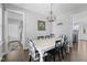 Bright dining room featuring a modern chandelier, rustic table, and stylish black-and-white chairs at 123 Hawick Ct, Zebulon, NC 27597