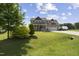 Charming two-story home with a well-manicured lawn, two-car garage, and inviting front porch at 123 Hawick Ct, Zebulon, NC 27597