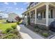 Inviting front porch with decorative plants, flowers, and a walkway leading to the home at 123 Hawick Ct, Zebulon, NC 27597