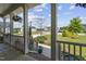 Covered front porch featuring white railings, hanging flower baskets, and view of a serene neighborhood at 123 Hawick Ct, Zebulon, NC 27597
