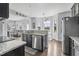 Modern kitchen featuring granite countertops, stainless steel appliances, and an open concept design to the living room at 123 Hawick Ct, Zebulon, NC 27597