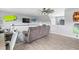 Comfortable living room featuring hardwood floors, ceiling fan, television, and stylish decor at 123 Hawick Ct, Zebulon, NC 27597