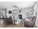 Cozy living room showcasing a fireplace, comfortable seating, a ceiling fan, and lots of natural light at 123 Hawick Ct, Zebulon, NC 27597