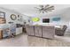 Bright living room features comfortable reclining sofa, workspace, and surfboards as decorative elements at 123 Hawick Ct, Zebulon, NC 27597