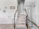 Carpeted staircase with wooden handrails and decorative wall decor, leading to the upper level at 123 Hawick Ct, Zebulon, NC 27597