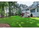 The backyard features a well-maintained lawn, a deck, and an outdoor stone fireplace at 1241 Keith Rd, Wake Forest, NC 27587