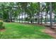 Spacious backyard featuring a well-maintained lawn and mature trees, offering privacy and tranquility at 1241 Keith Rd, Wake Forest, NC 27587