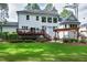 Expansive backyard with a patio, wooden deck, and a cozy pergola with an outdoor fireplace, perfect for entertaining at 1241 Keith Rd, Wake Forest, NC 27587