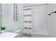 Full tub/shower in a bathroom with neutral tile and decorative touches at 1241 Keith Rd, Wake Forest, NC 27587