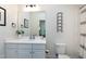 White bathroom vanity with sink and toilet adjacent to the combination shower and tub at 1241 Keith Rd, Wake Forest, NC 27587