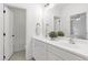 Bright bathroom featuring double sinks, white cabinets, and a view into the shower/tub at 1241 Keith Rd, Wake Forest, NC 27587
