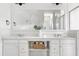 Bright bathroom featuring double vanity with quartz countertop and white cabinets at 1241 Keith Rd, Wake Forest, NC 27587