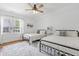 Bedroom with ceiling fan, hardwood floors, two twin beds, and white walls at 1241 Keith Rd, Wake Forest, NC 27587
