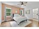 Bedroom with hardwood floors and large windows with view to the backyard at 1241 Keith Rd, Wake Forest, NC 27587