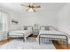 Bright bedroom featuring hardwood floors, two twin beds, and large window at 1241 Keith Rd, Wake Forest, NC 27587