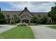 Elegant clubhouse with stone facade and mature trees, offering a welcoming and refined atmosphere at 1241 Keith Rd, Wake Forest, NC 27587