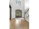 Entryway featuring hardwood floors, glass paneled double doors, and a staircase with a view of the office at 1241 Keith Rd, Wake Forest, NC 27587