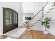 Bright entryway features hardwood floors, stairs with wood railing, a view to the office at 1241 Keith Rd, Wake Forest, NC 27587