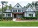 Beautiful two-story home with white siding, black shutters, wood porch columns and manicured lawn at 1241 Keith Rd, Wake Forest, NC 27587