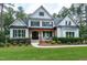 Charming two-story home with a welcoming front porch, well-manicured lawn, and mature landscaping at 1241 Keith Rd, Wake Forest, NC 27587