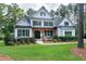 Inviting two-story home with a covered front porch, complemented by manicured landscaping at 1241 Keith Rd, Wake Forest, NC 27587