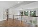 Upstairs hallway features hardwood floors and lots of natural light at 1241 Keith Rd, Wake Forest, NC 27587