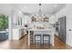 Modern white kitchen featuring a large island, stainless steel appliances, and an open layout at 1241 Keith Rd, Wake Forest, NC 27587