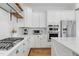 Kitchen featuring white cabinets, stainless steel appliances, and a gas cooktop set against a subway tile backsplash at 1241 Keith Rd, Wake Forest, NC 27587