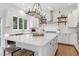 Beautiful kitchen with white cabinets, hardwood floors, a white island with stools, and stainless steel appliances at 1241 Keith Rd, Wake Forest, NC 27587