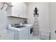 The laundry room is equipped with modern washer and dryer units and upper cabinets at 1241 Keith Rd, Wake Forest, NC 27587