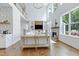 Bright living room with open layout, featuring fireplace, large windows, and built-in shelving at 1241 Keith Rd, Wake Forest, NC 27587