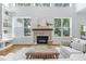 Spacious living room featuring a fireplace, built-in shelving, and large windows for ample natural light at 1241 Keith Rd, Wake Forest, NC 27587