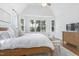 Bright main bedroom with a cozy seating area, hardwood floors, and large windows providing ample natural light at 1241 Keith Rd, Wake Forest, NC 27587