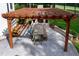 Overhead view of a wooden pergola with a brick fireplace and dining area overlooking a verdant lawn at 1241 Keith Rd, Wake Forest, NC 27587