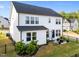 Backyard featuring a patio area with a fire pit, string lights, and mature landscaping at 128 Highland Grove Way, Fuquay Varina, NC 27526