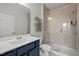 Bathroom featuring a glass-enclosed shower, vanity, and modern fixtures for a spa-like experience at 128 Highland Grove Way, Fuquay Varina, NC 27526