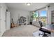 Bright bedroom with large windows, neutral carpet, and a view of the neighborhood at 128 Highland Grove Way, Fuquay Varina, NC 27526