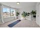 Bright bonus room featuring large windows, neutral carpet, and ample space for activities at 128 Highland Grove Way, Fuquay Varina, NC 27526