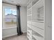 Organized walk-in closet with custom shelving, drawers, and a large window for natural light at 128 Highland Grove Way, Fuquay Varina, NC 27526