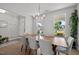 Bright dining room featuring a large wood table with seating for eight and view of the lovely neighborhood at 128 Highland Grove Way, Fuquay Varina, NC 27526