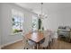 Bright dining room with ample natural light and a stylish bar cart at 128 Highland Grove Way, Fuquay Varina, NC 27526