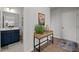 Inviting entryway with wood console table and stylish decor leading to a well-appointed bathroom at 128 Highland Grove Way, Fuquay Varina, NC 27526
