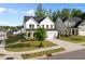 A two-story home featuring a two-car garage and a covered porch with a comfortable seating area at 128 Highland Grove Way, Fuquay Varina, NC 27526
